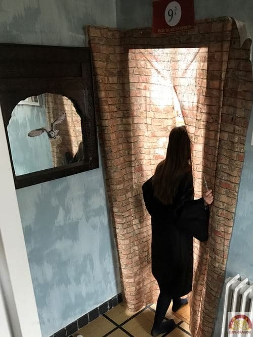fille qui traverse le mur de briques de la voie 9 3/4