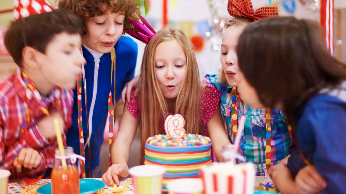 enfants autour d'un gateau anniversaire avec bougie