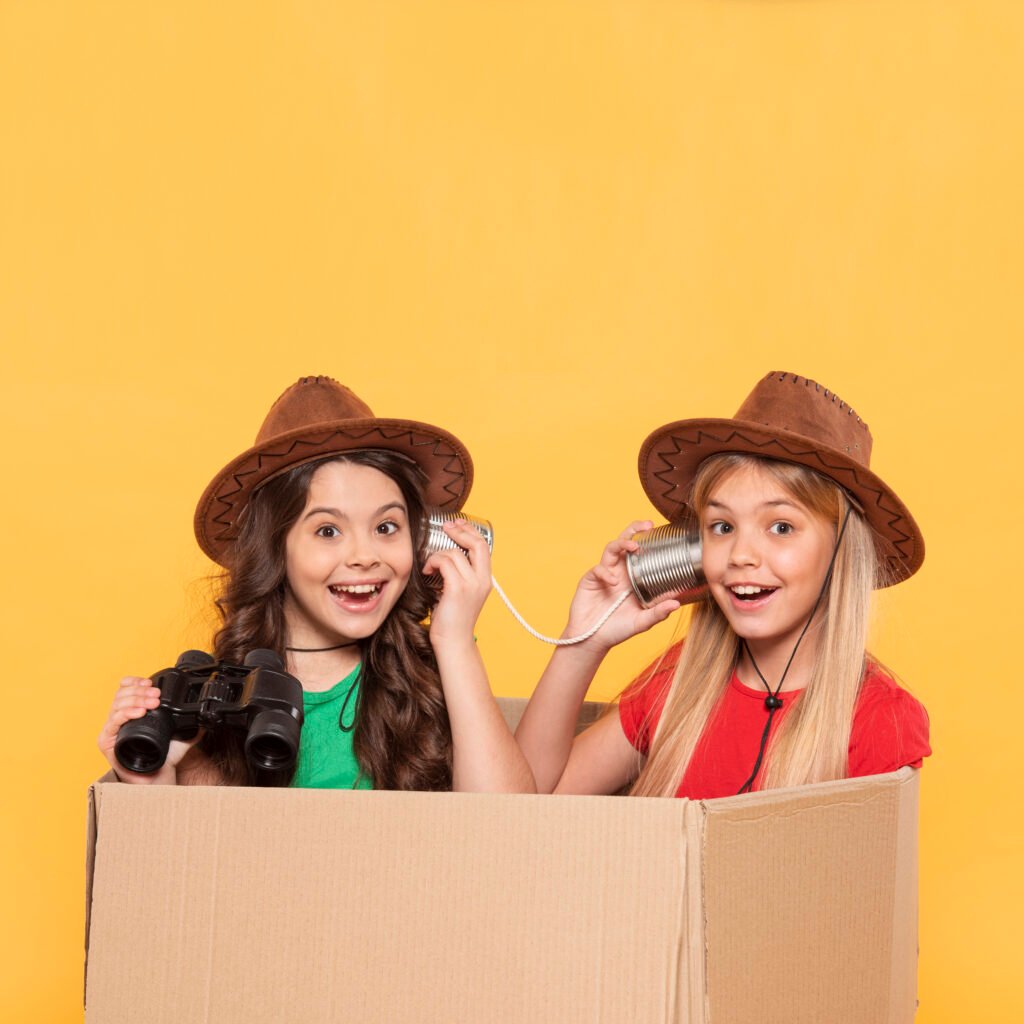 little-girl-with-hat-playing-in-cartoon-box